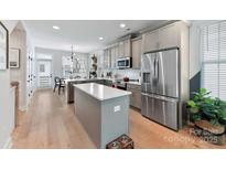 Bright kitchen with stainless steel appliances, kitchen island and an adjacent dining area at 316 S Turner Ave # 11, Charlotte, NC 28208