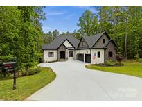 Stunning exterior of a modern two-story home with a long driveway and three-car garage at 4135 Mineral Ln, Lincolnton, NC 28092