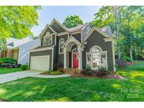 Charming home with a red front door, well-maintained lawn, and inviting curb appeal at 4201 Beauvista Dr, Charlotte, NC 28269