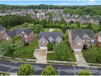 Beautiful brick home featuring a well-manicured lawn and a two-car garage in a quiet neighborhood at 422 Deer Brush Ln, Waxhaw, NC 28173
