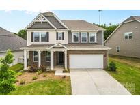 Charming two-story home featuring a brick and siding exterior, attached two car garage, and landscaped front yard at 423 Shallowford Dr, Rock Hill, SC 29732