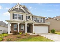 Two-story home featuring a brick and siding exterior, a two-car garage, and a covered front porch at 423 Shallowford Dr, Rock Hill, SC 29732