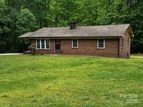 Charming brick ranch home on a large lot with mature trees and well-maintained lawn at 5068 King Wilkinson Rd, Denver, NC 28037