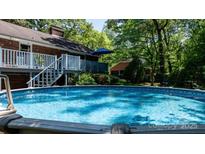 Relaxing above-ground pool with inviting blue water, deck, and peaceful backyard setting at 701 5Th Ne Ave, Conover, NC 28613