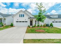 Charming single-story home featuring a white exterior, well-manicured lawn, and attached two car garage at 8008 Brookbank Dr, Charlotte, NC 28269