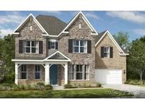 Beautiful two-story stone and brick home featuring a symmetrical design and manicured landscaping at 11913 Casabella Dr, Huntersville, NC 28078