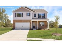 Charming two-story home with brick and vinyl siding, attached garage and manicured front lawn at 1390 6Th Ne St, Hickory, NC 28601