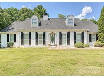 Charming one-story brick home with black shutters and a manicured lawn at 208 Armstrong Dr, Belmont, NC 28012