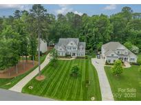 Stunning aerial view of a luxurious home featuring lush landscaping and a long driveway at 212 Seven Oaks Lndg, Belmont, NC 28012