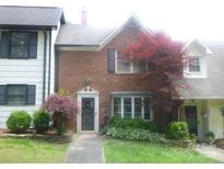 Charming brick townhouse featuring manicured landscaping and mature trees in a desirable location at 214 Idlewood Dr, Kannapolis, NC 28083