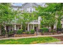 Charming gray townhome with a well-maintained front yard and a black iron fence at 258 Iverson Way, Charlotte, NC 28203