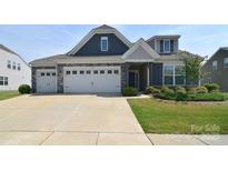 Charming two-story home with a three car garage, stone accents and a well-manicured lawn at 3073 Oliver Stanley Trl, Lancaster, SC 29720