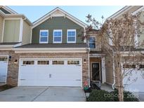 Charming two-story home featuring a stone facade, a two-car garage, and a well-manicured lawn at 5063 Gribble Ln, Lancaster, SC 29720