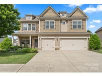 Attractive two-story home with a two car garage, stone accents, and well-maintained landscaping at 1011 Potomac Rd, Indian Trail, NC 28079