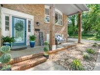 Charming front porch with brick accents, decorative plants, and comfortable seating area at 1110 16Th Avenue Nw Pl, Hickory, NC 28601