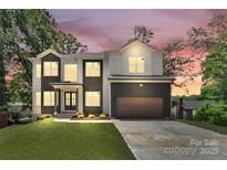 Beautiful modern home with a two-car garage and well-manicured lawn and professional landscaping at 124 Clipper Ln, Mooresville, NC 28117