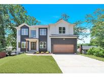 Charming two-story home with a modern design, well-maintained lawn, and beautiful, bright blue sky at 124 Clipper Ln, Mooresville, NC 28117
