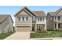 Charming two-story home with a well-maintained lawn and attached garage at 128 Championship Dr, Mooresville, NC 28115