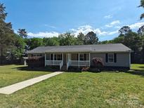 Charming single-story home with a welcoming front porch and well-manicured lawn at 1495 Carson Rd, Cleveland, NC 27013