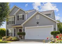 Charming two-story home features a two-car garage, well-maintained lawn, and beautiful landscaping at 1525 Moss Creek Dr, Harrisburg, NC 28075