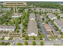 Aerial view showcases the community's pool, clubhouse, recreational area, garage, and ground floor unit at 16610 Amberside E Rd, Cornelius, NC 28031