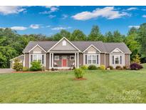 Charming exterior of home with well-manicured lawn, covered porch, and meticulous landscaping at 2853 Mathis Church Rd, Catawba, NC 28609