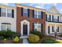 Charming red brick townhome with black shutters and well-maintained landscaping in a residential neighborhood at 3021 Misty Harbor Cir, Cramerton, NC 28032