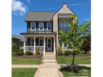 Charming two-story home with brick accents, a cozy front porch, and beautiful landscaping at 397 Luray Way, Rock Hill, SC 29730
