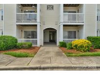Inviting entrance to the property with well-manicured landscaping and multiple units at 4072 Town Center Rd, Harrisburg, NC 28075