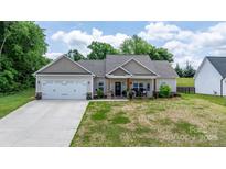 Charming single-story home with a covered front porch and well-manicured lawn at 4949 Southview Dr, Hickory, NC 28602