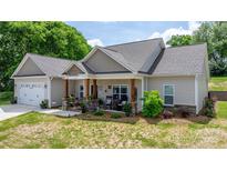 Charming single-story home with stone accents, covered porch, and attached two-car garage at 4949 Southview Dr, Hickory, NC 28602