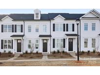 Charming new construction townhome with black shutters and coordinated landscaping at 8118 Jacey Ln # 20, Huntersville, NC 28078