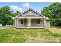 Charming single-story home with a welcoming front porch and gray siding at 842 Murphy St, Kannapolis, NC 28081