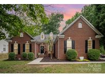 Charming one-story brick home with manicured lawn and inviting entrance at 10011 Spring Park Dr, Charlotte, NC 28269