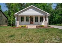 Charming single-story home with a welcoming front porch and beautifully landscaped yard, offering great curb appeal at 1012 W Carroll St, Cherryville, NC 28021