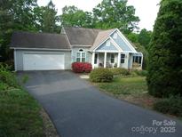 Charming single-story home with a long drive, attached garage, and inviting covered front porch at 109 Gatwick Ct, Statesville, NC 28677
