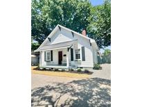 Charming renovated home with a welcoming front porch and tidy landscaping features at 229 W Gray Ave, Mooresville, NC 28115