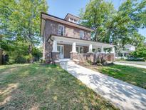 Charming two-story brick home with a welcoming front porch, perfect for relaxing and enjoying the neighborhood views at 300 W Thomas St, Salisbury, NC 28144
