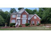 Charming two-story red brick home with manicured landscaping and a welcoming front porch at 3104 Highgate Dr, Fort Mill, SC 29715