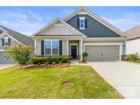 Charming single-Gathering home featuring manicured lawn, neutral colors, and a two-car garage at 329 Secretariat Dr, Iron Station, NC 28080