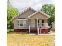 Charming one-story home features a welcoming front porch and manicured lawn at 420 Baker Street Ext, Rock Hill, SC 29730