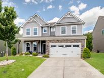 Charming two-story home with stone accents, lush lawn and a spacious two car garage at 4316 Falls Lake Sw Dr, Concord, NC 28025