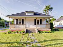 Charming home featuring a inviting front porch, manicured lawn, and pathway at 55 Ranlo Ave, Gastonia, NC 28054