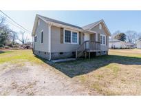 Charming single-story home with neutral siding, green shutters and a small front porch at 819 W Rankin Ave, Gastonia, NC 28052