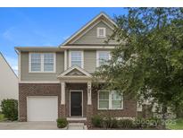 Charming two-story home featuring brick and siding, a front porch, and an attached garage at 838 Von Buren Blvd, Rock Hill, SC 29730