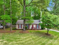 Charming single-story home with red shutters and a well-manicured lawn surrounded by mature trees at 10200 Cairnsmore Pl # 9, Mint Hill, NC 28227