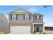 Two-story home with gray siding, blue shutters, brick accents, and a two-car garage, presenting a modern and inviting curb appeal at 1023 Hostler Ln, York, SC 29745