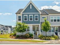 Charming townhome with blue siding, a cozy porch, and well-maintained landscaping at 119 Berkeley Ave # A, Mooresville, NC 28117