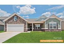 Charming home featuring a stone facade, well-manicured lawn, and a welcoming covered porch at 6320 Busch Way, Midland, NC 28107