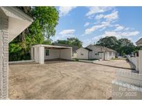 Large backyard featuring a carport and an outbuilding for parking and storage at 1211 N Boyce St, Gastonia, NC 28052